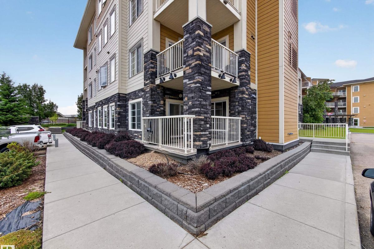 Ground-floor patio and building exterior at #121, 3670 139 Avenue NW