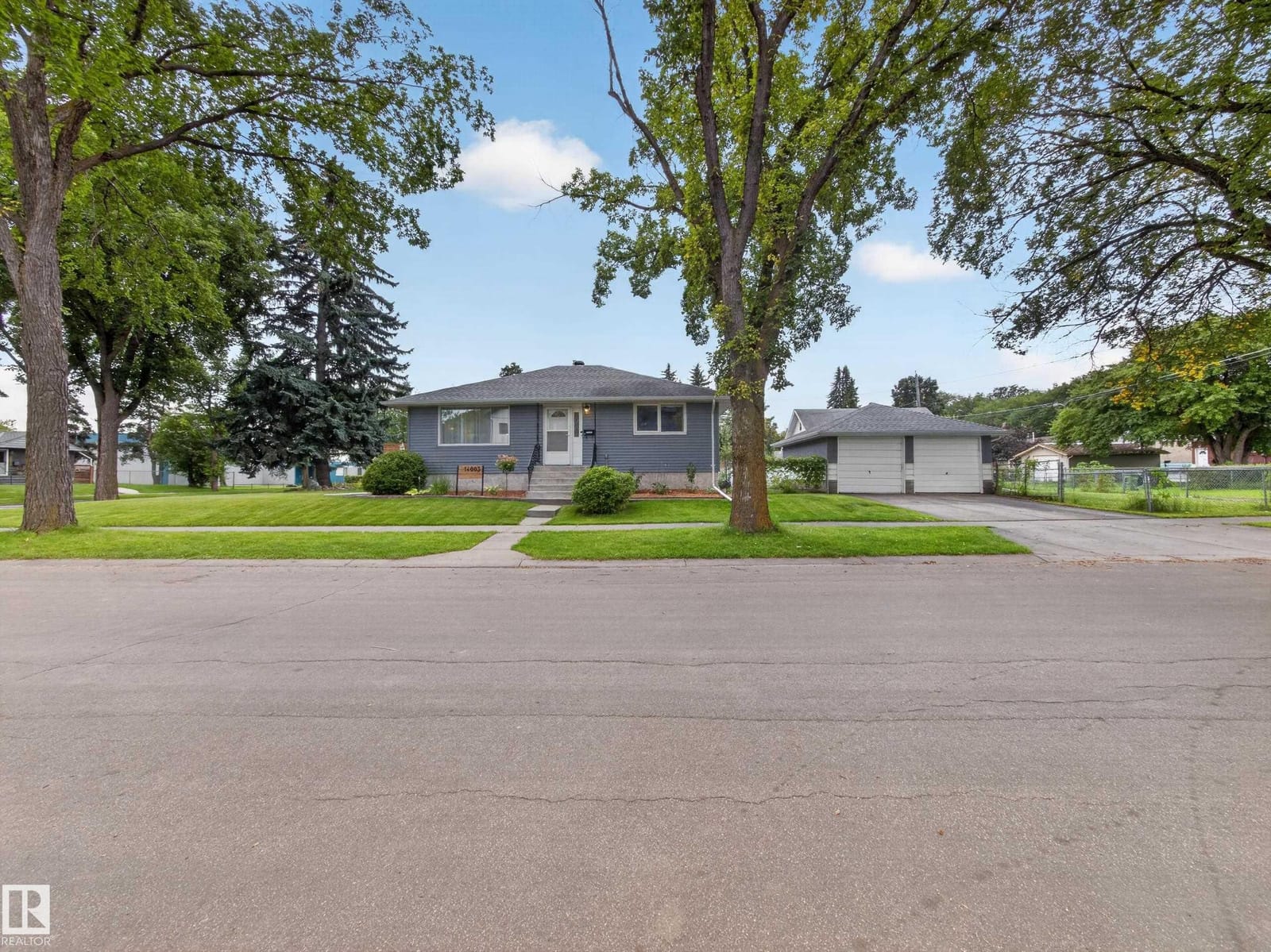 Tree-lined street looking toward the home