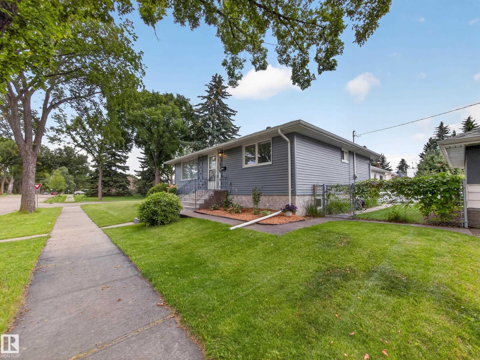 Front exterior with landscaped beds and walkway