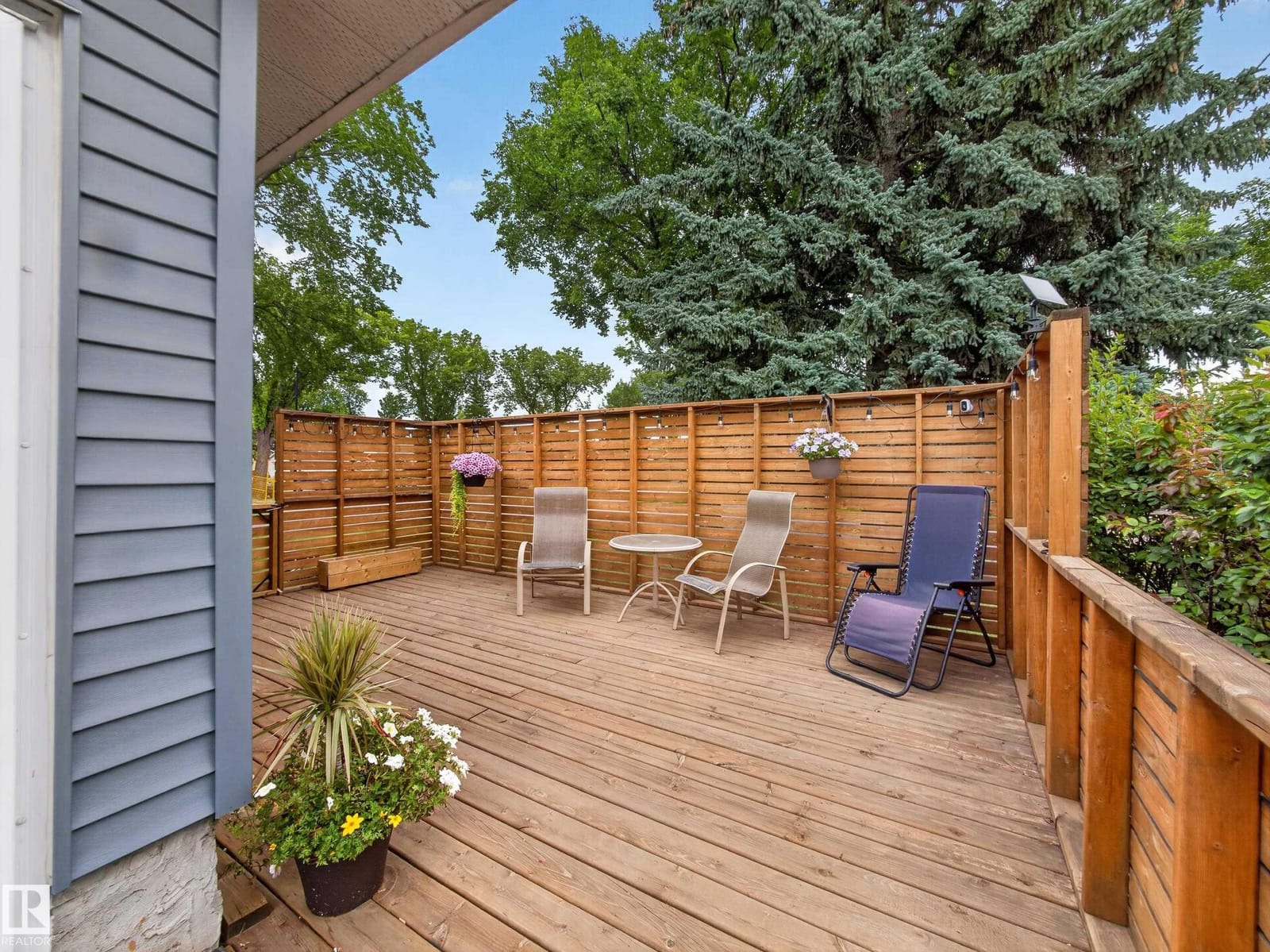 Private deck with patio seating and planters