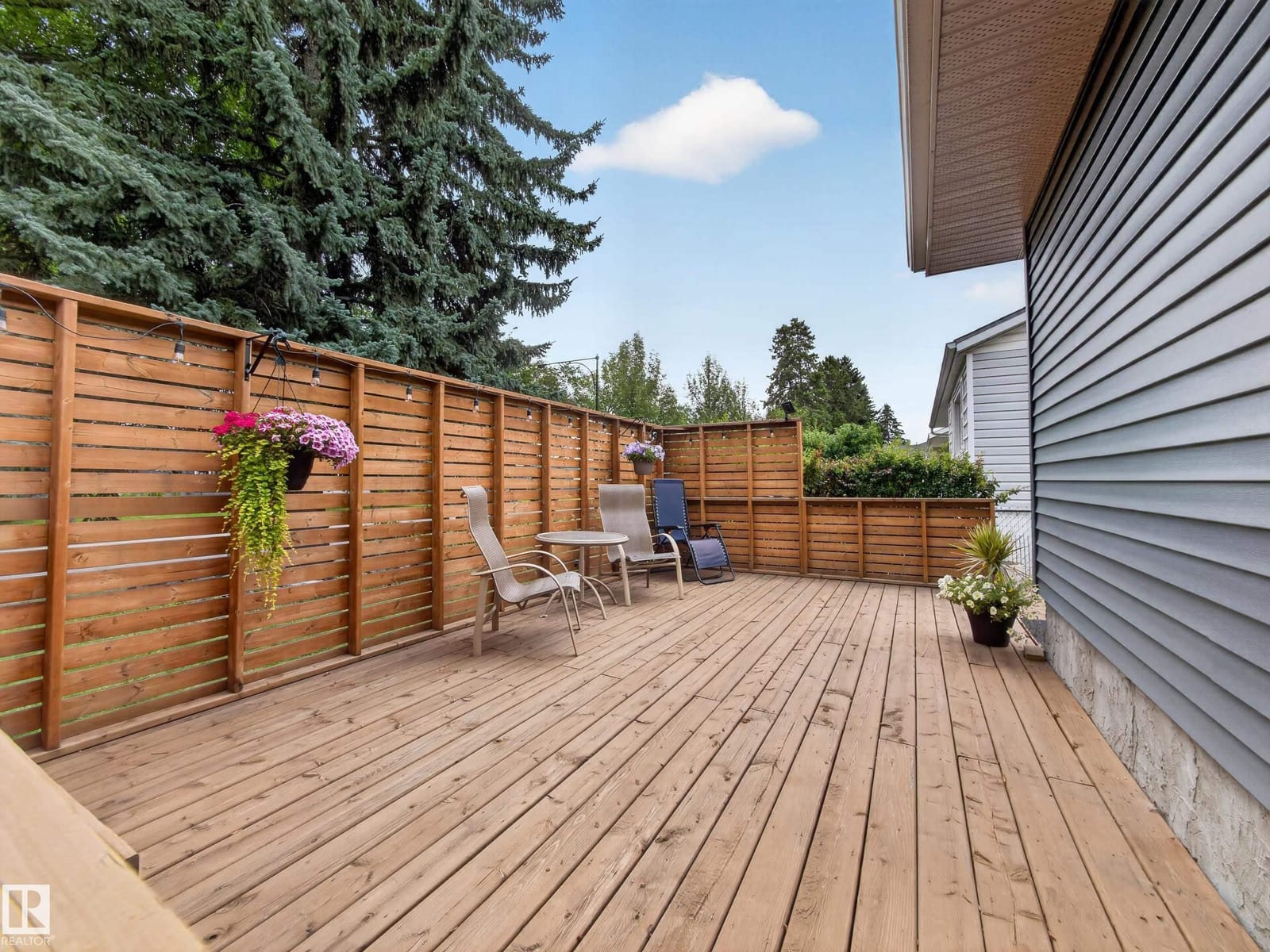 Deck with full-height fencing and garden planters