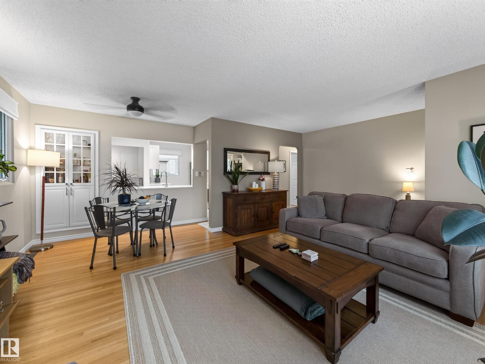 Living room with sectional seating, dining beyond