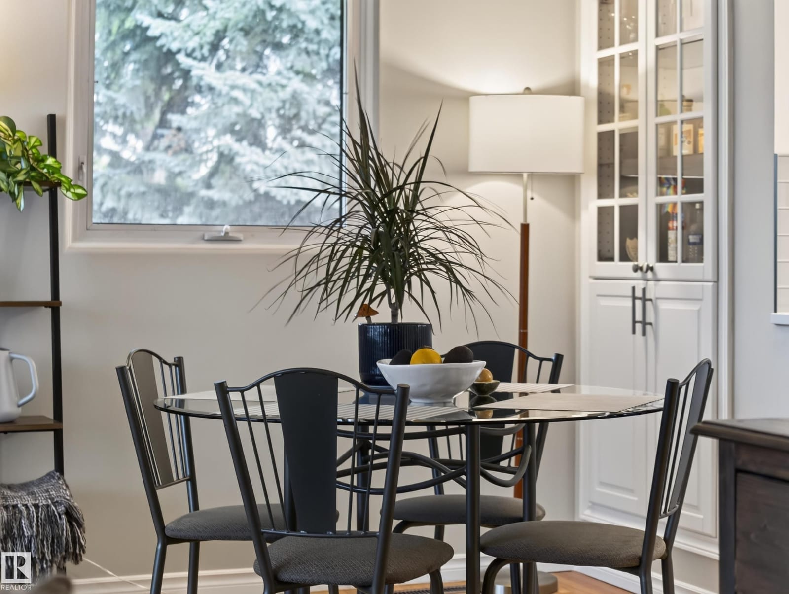 Dining area with window and white cabinetry