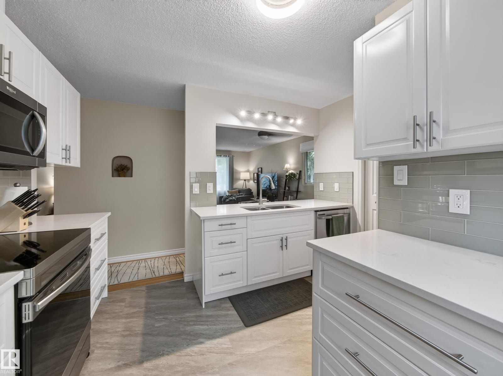 Kitchen with white cabinetry and tile backsplash