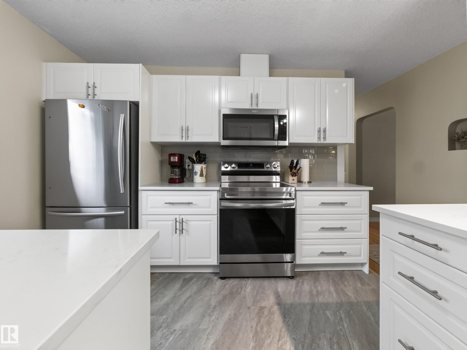 Kitchen with stainless appliances and vinyl plank flooring