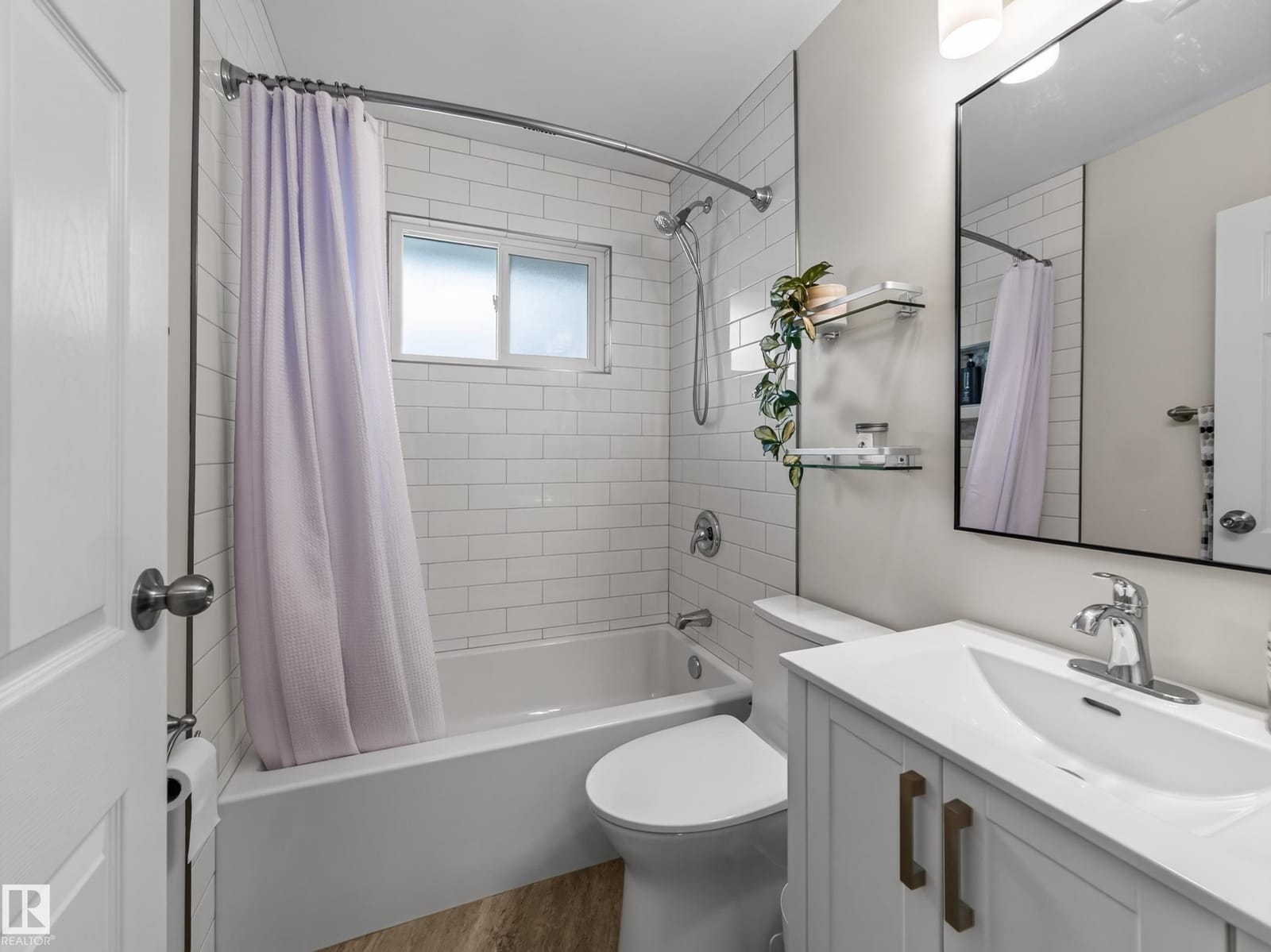 Full bathroom with tiled tub and shower surround