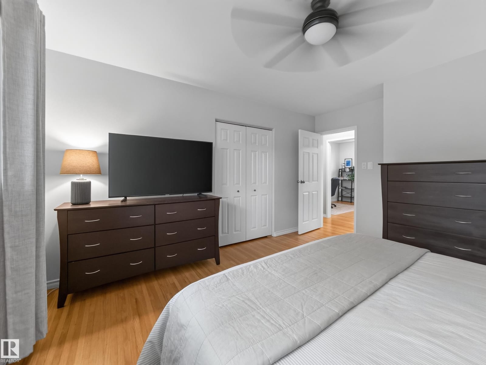 Bedroom with dresser and ceiling fan