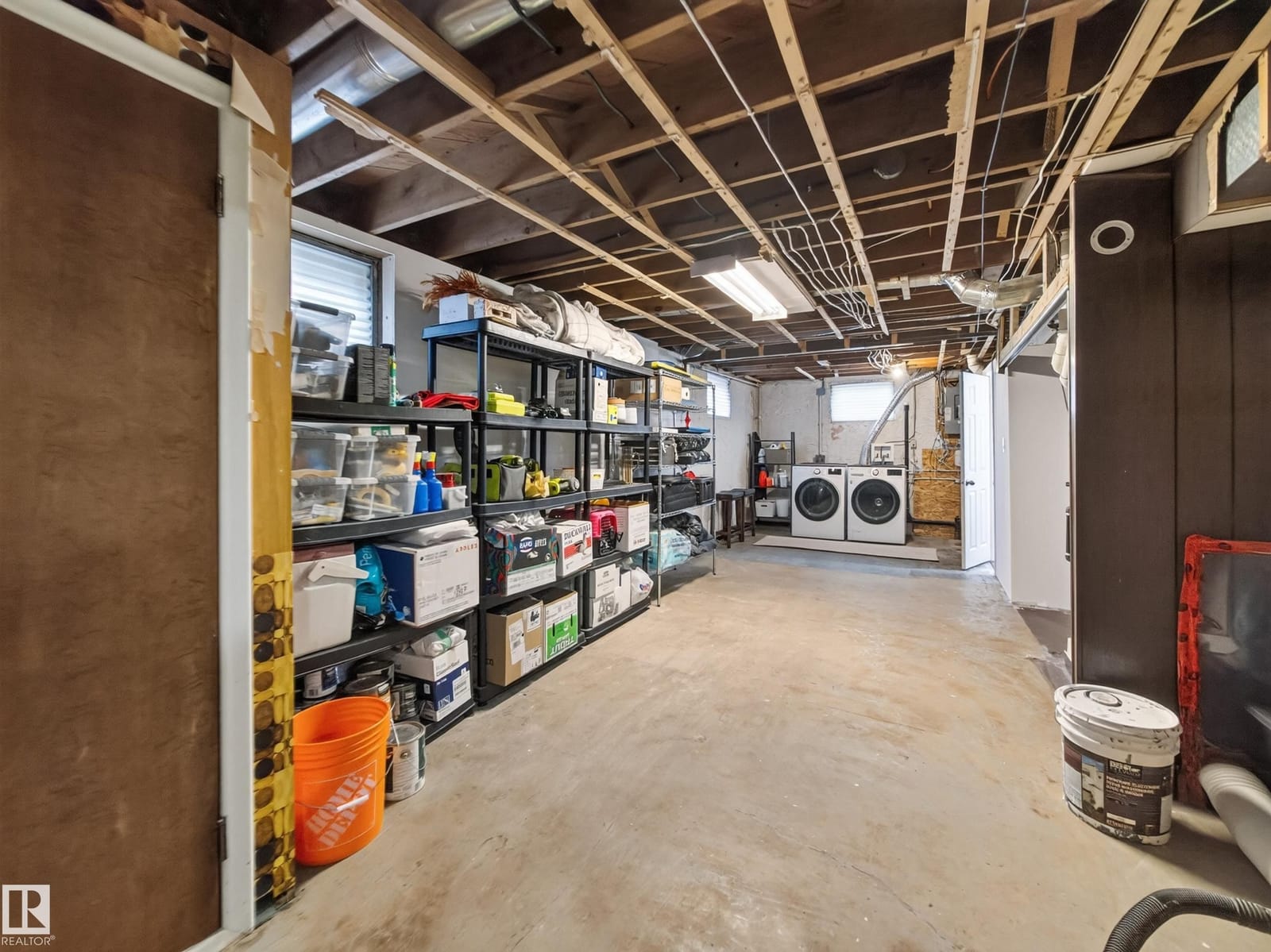 Laundry area with storage shelving