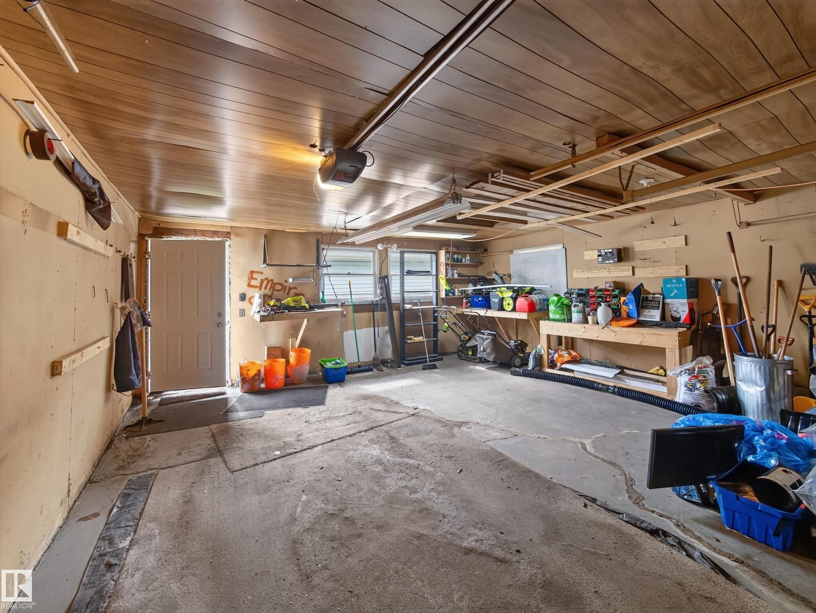 Garage interior with overhead door and storage