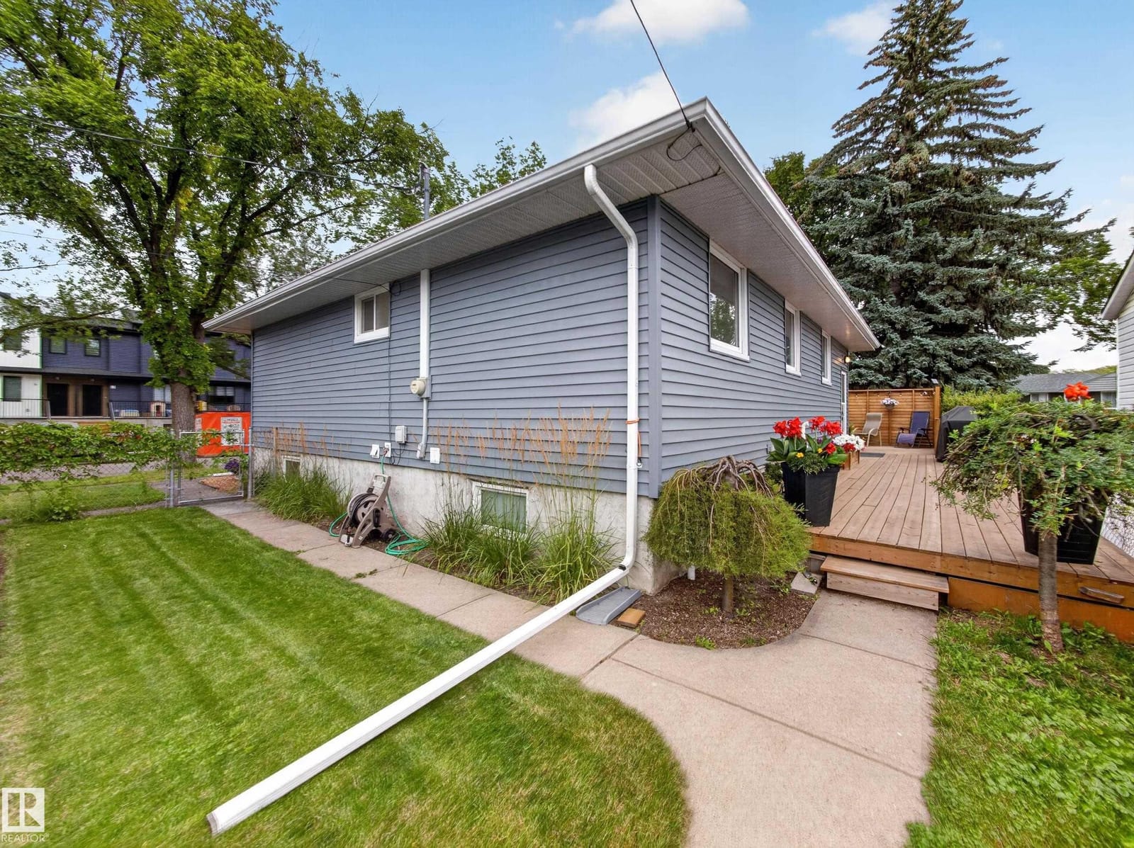 Side of the home with deck and landscaping