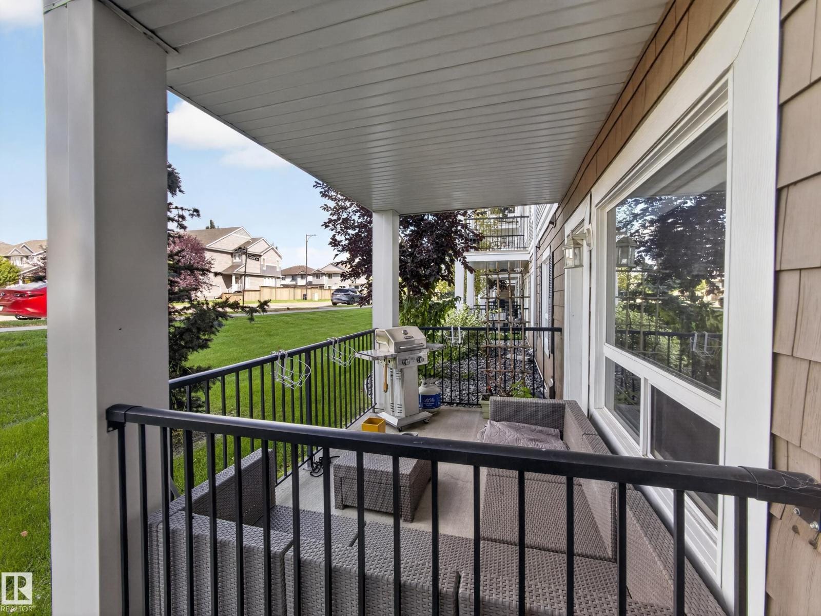 Covered patio railing looking out over green space