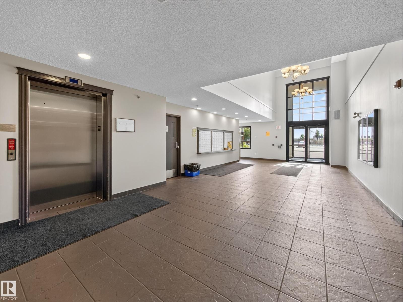 Building lobby with elevator and tiled entry