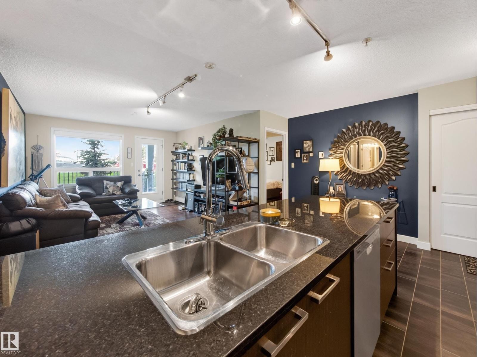 Living area and island sink with the patio door beyond