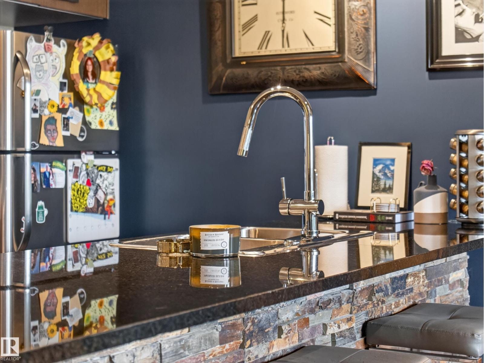 Island sink detail with granite counter and stone facing