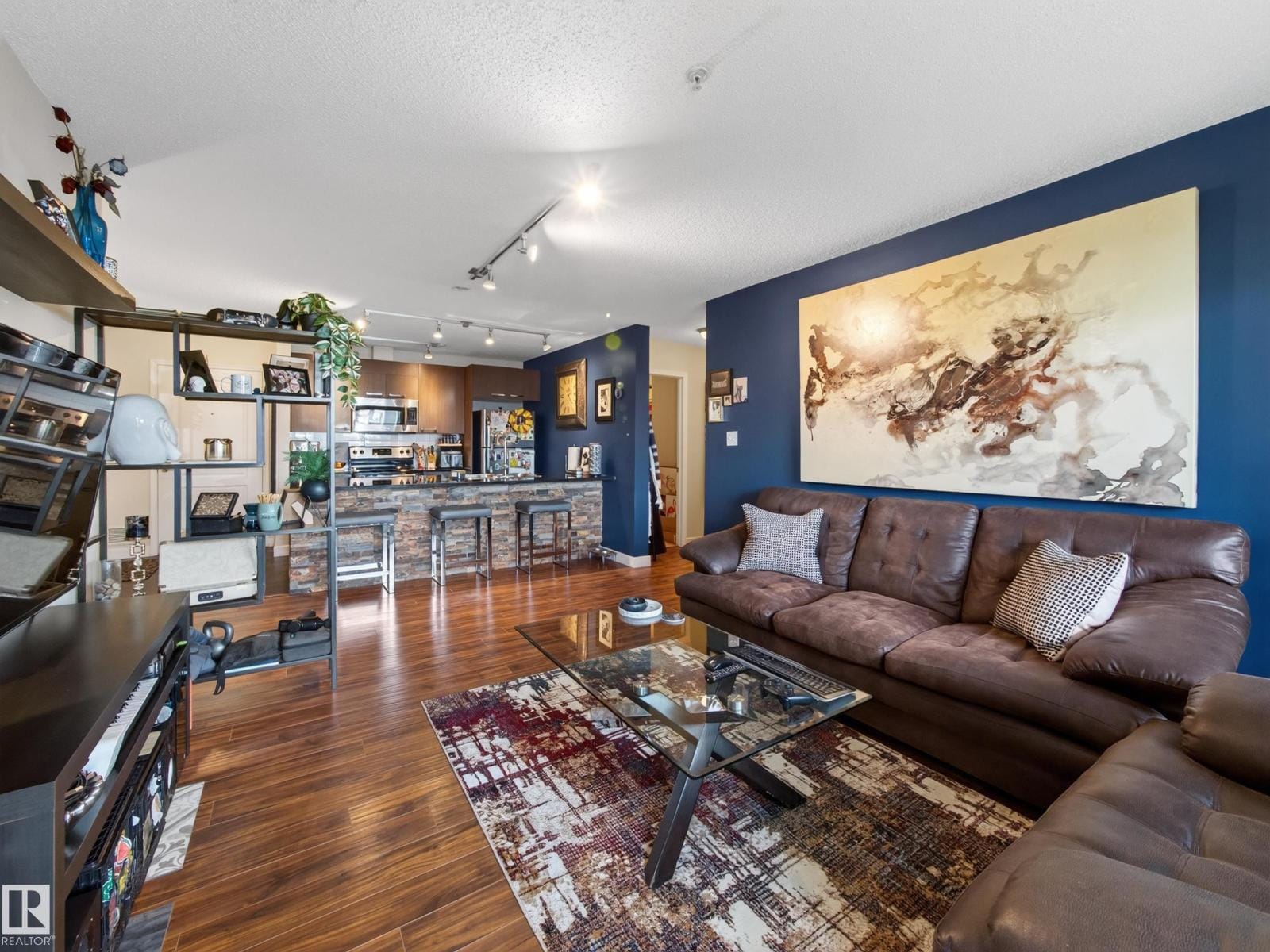 Open living and kitchen space with navy accent wall