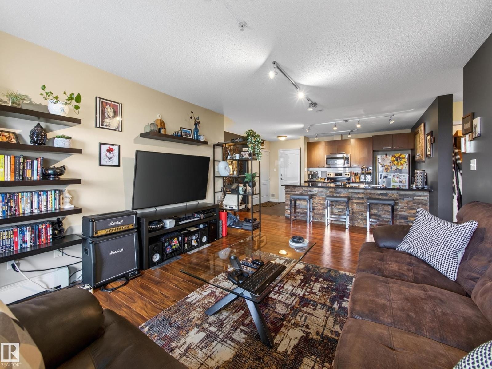 Wide view of the open living and kitchen space
