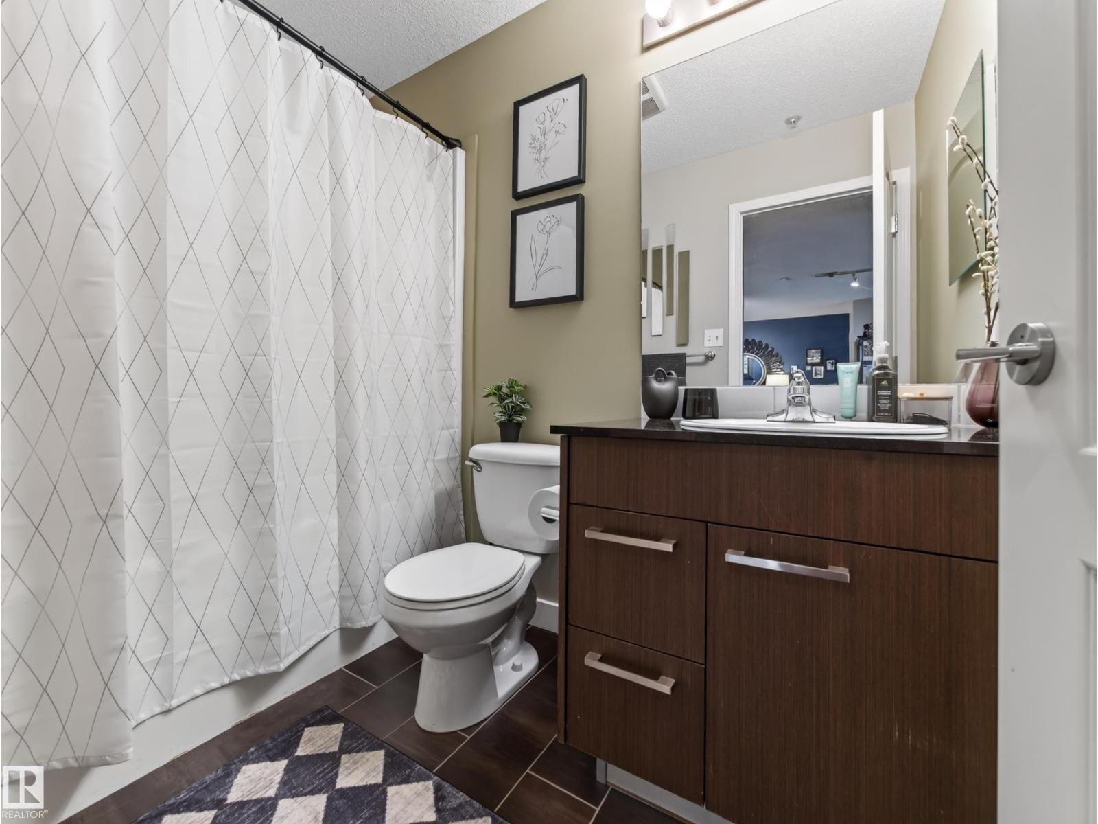 Full bathroom with tub and shower, dark vanity and tile floor