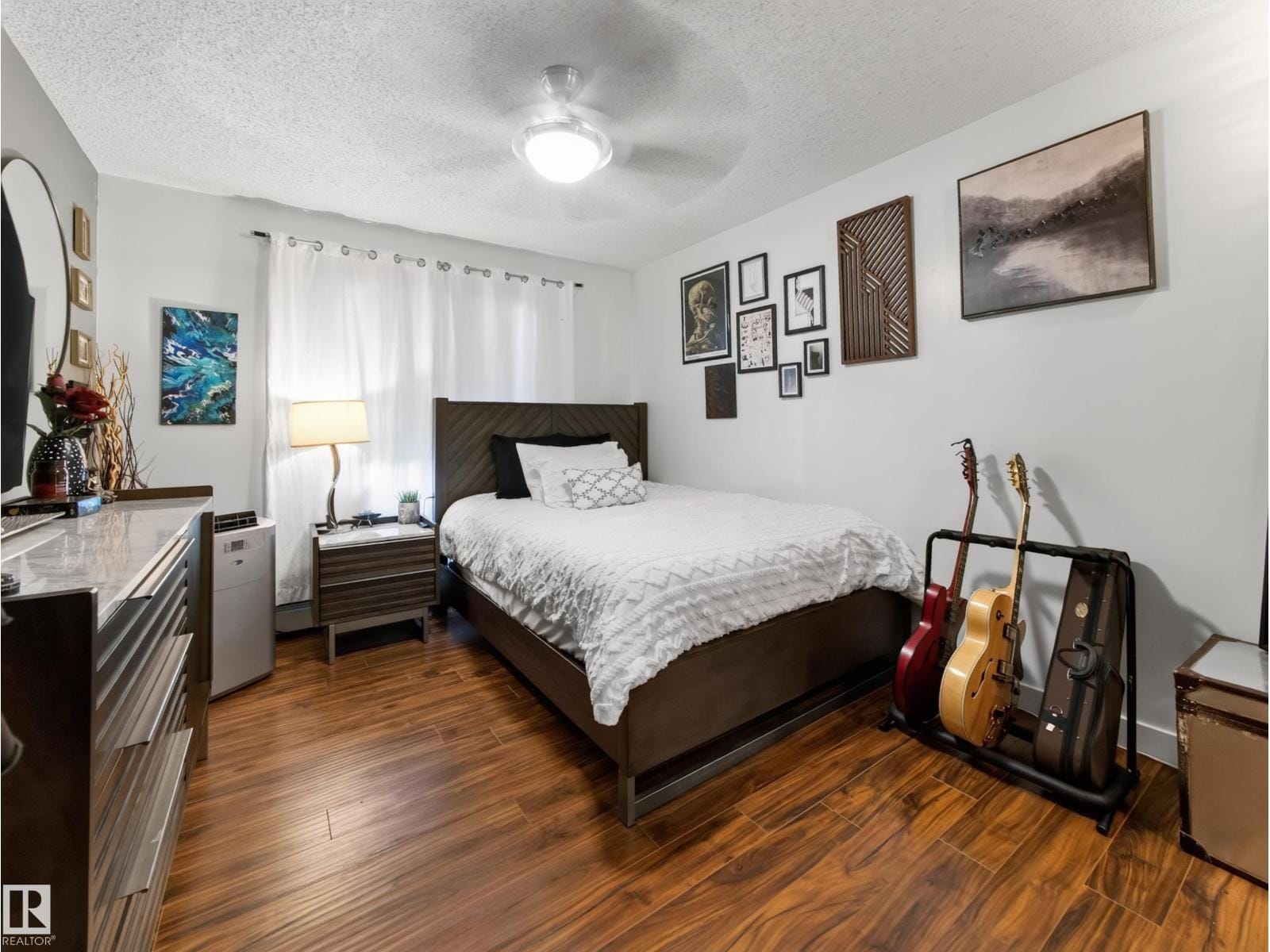 Bedroom with window, bed and dresser