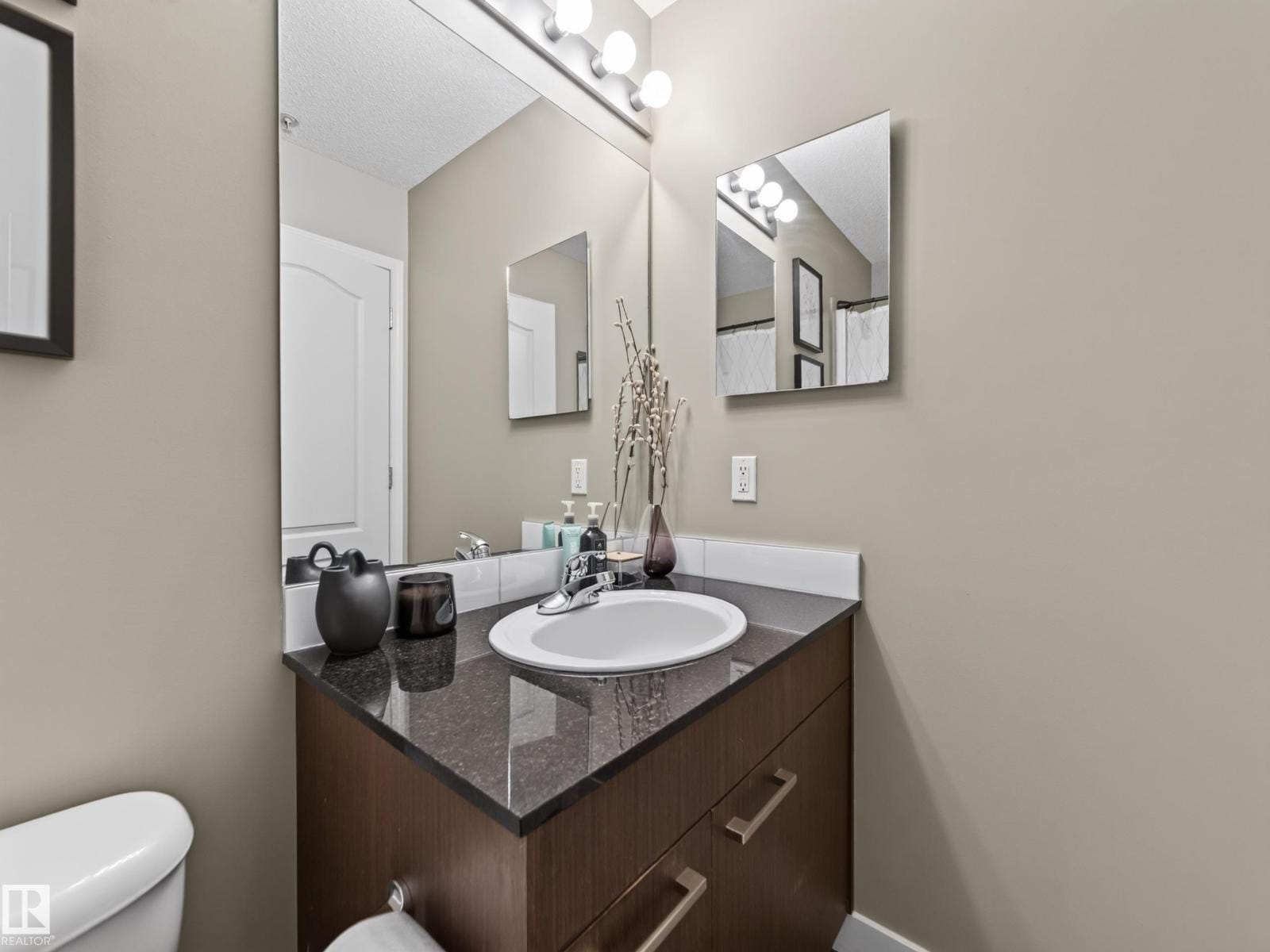 Bathroom vanity with granite counter and mirror