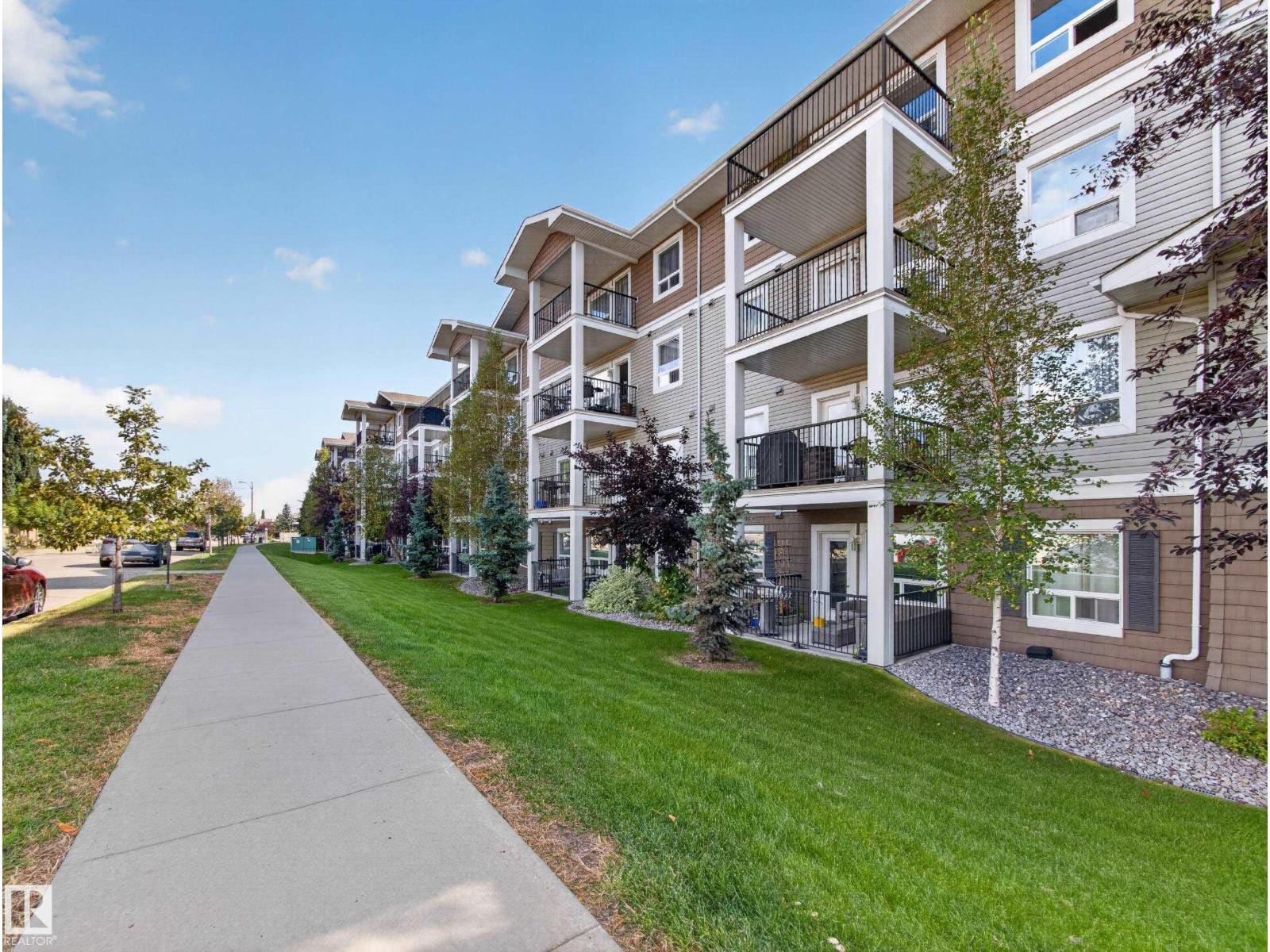 Walkway alongside the building with lawn and green space