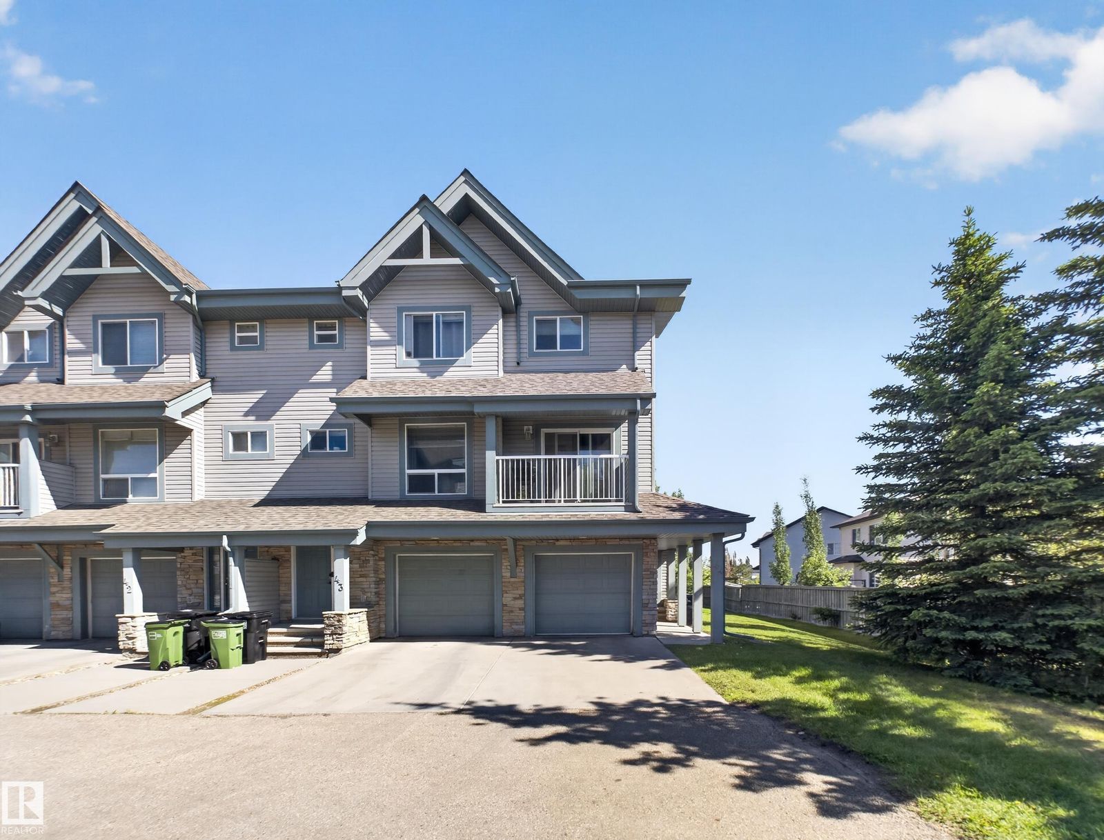 Front exterior of the end unit with attached garage and driveway