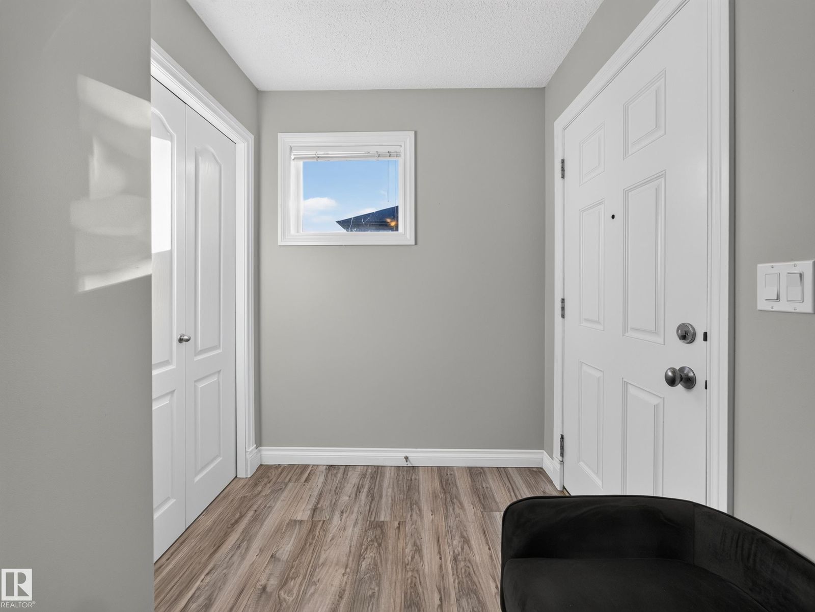 Entry with the front door and coat closet