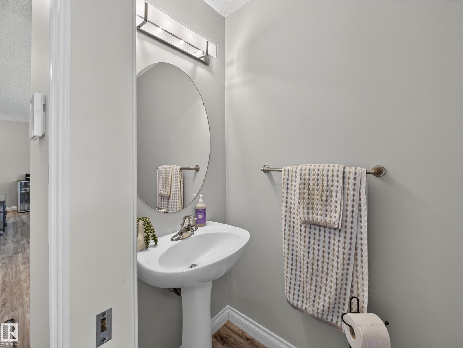 Main-floor powder room with pedestal sink