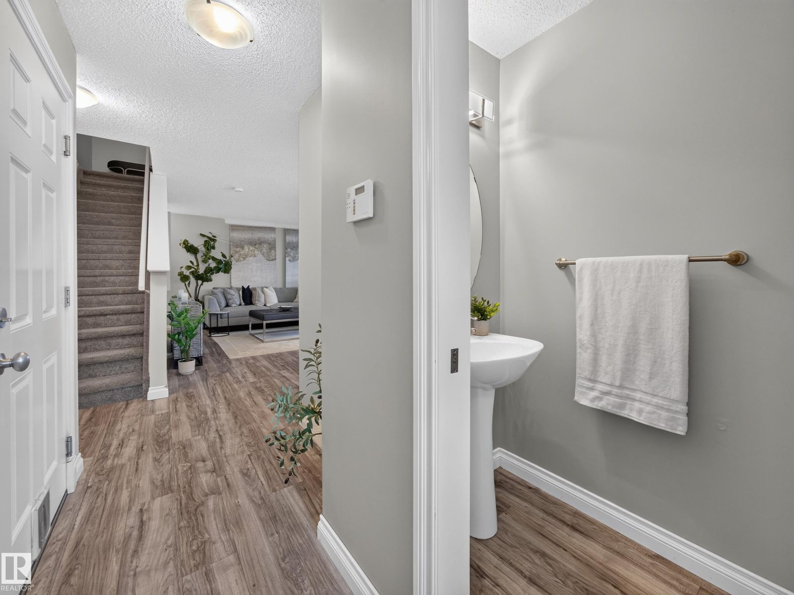 Hall past the powder room toward the stairs and living room
