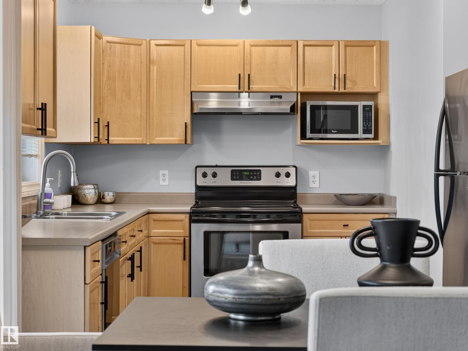 Kitchen with stainless range and over-range microwave