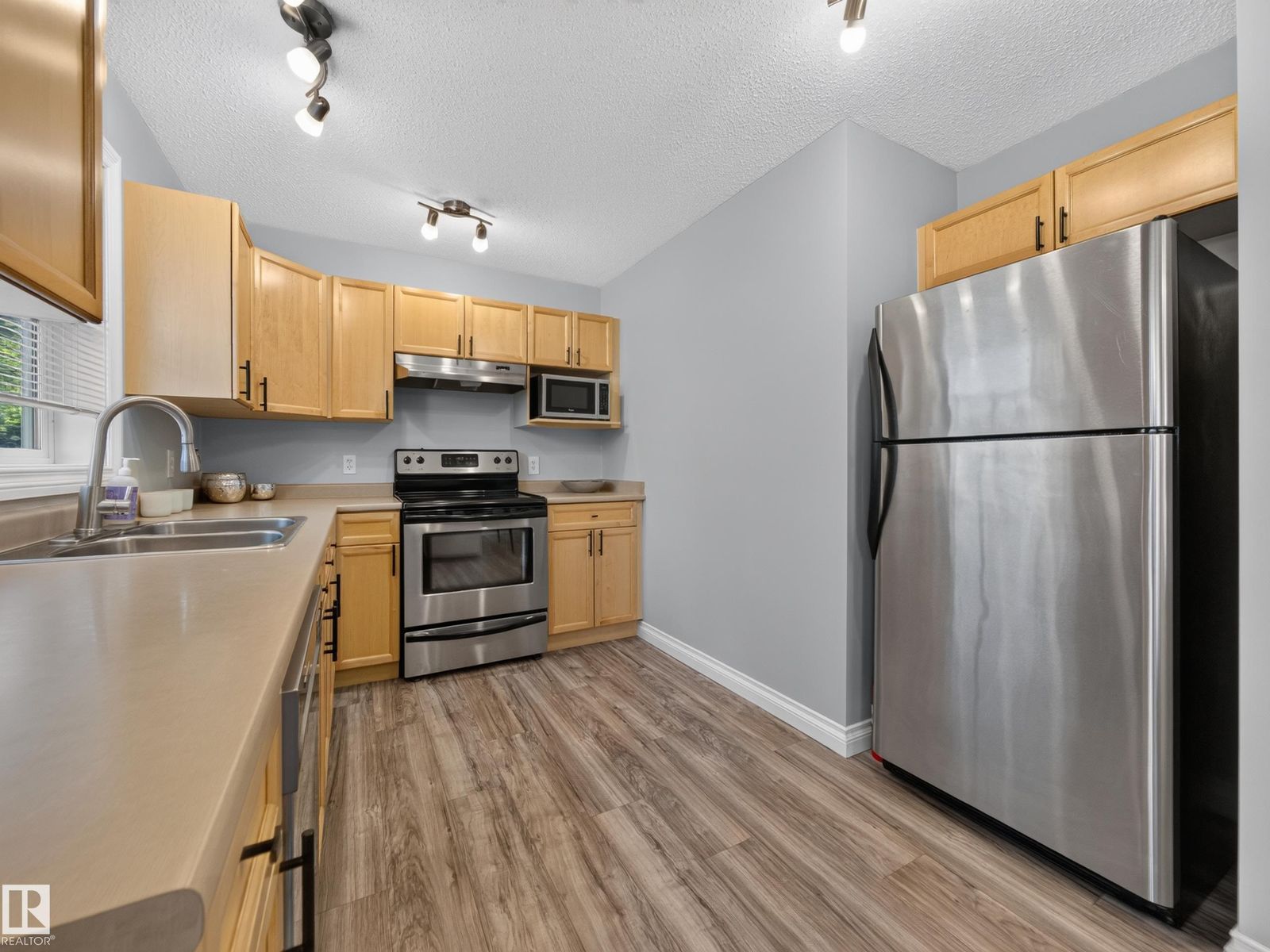 Kitchen with stainless fridge and range