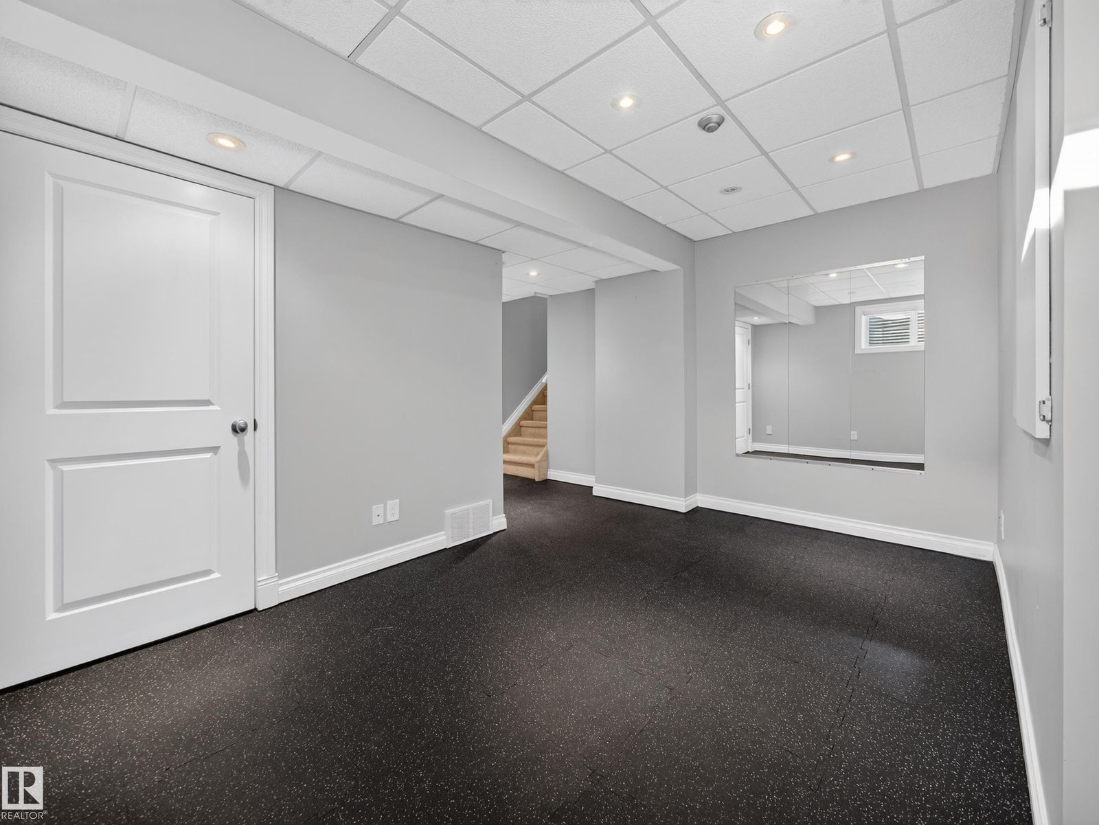 Finished basement rec room with rubber flooring