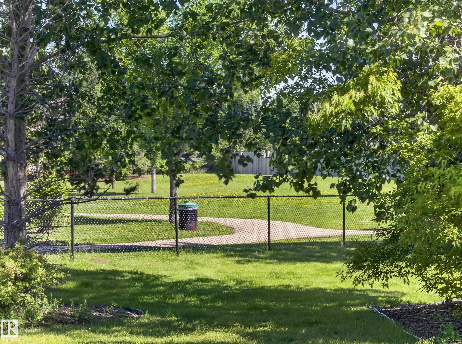 Green space and walking path beyond the back fence