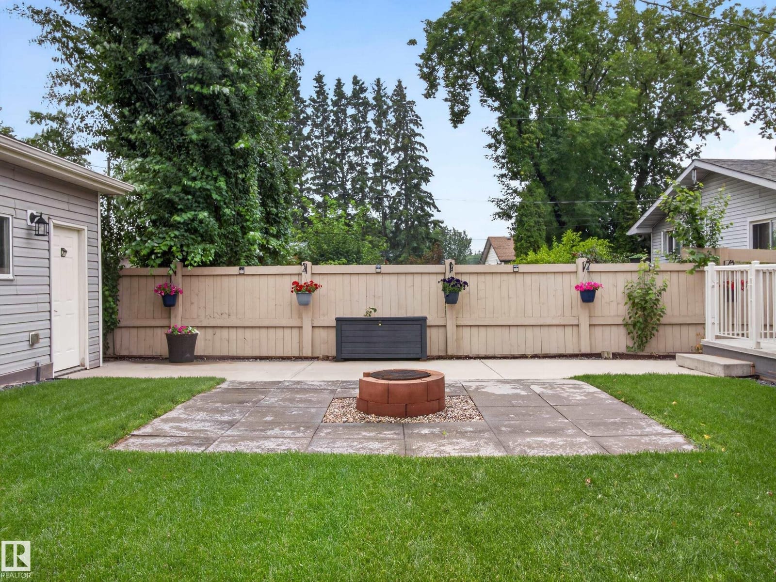 Back patio with fire pit and fenced yard