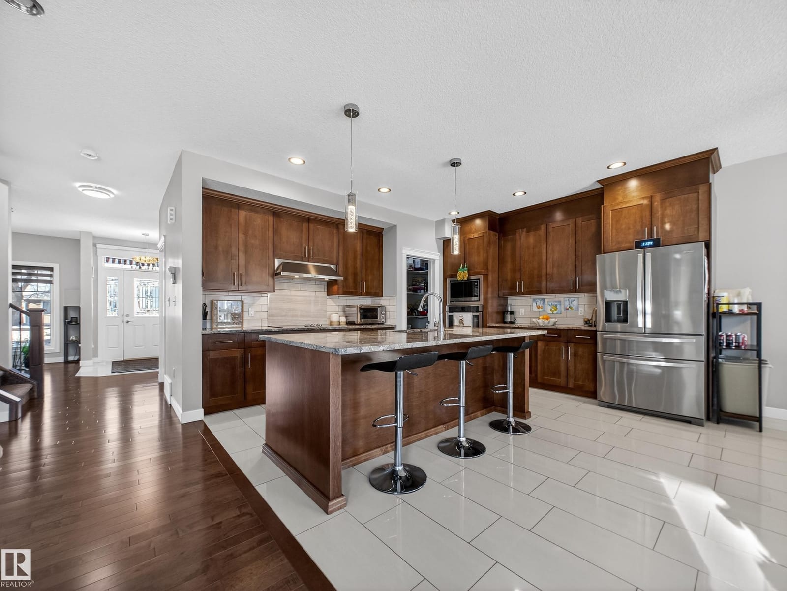 Kitchen with island, maple cabinetry and stainless appliances