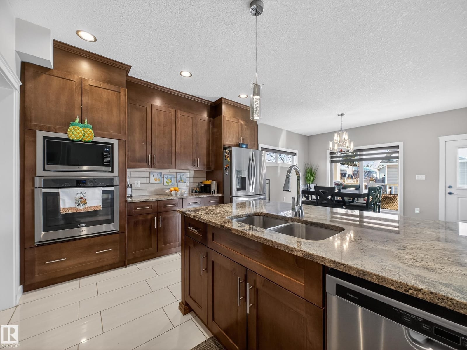 Kitchen sink and granite counter looking toward dining