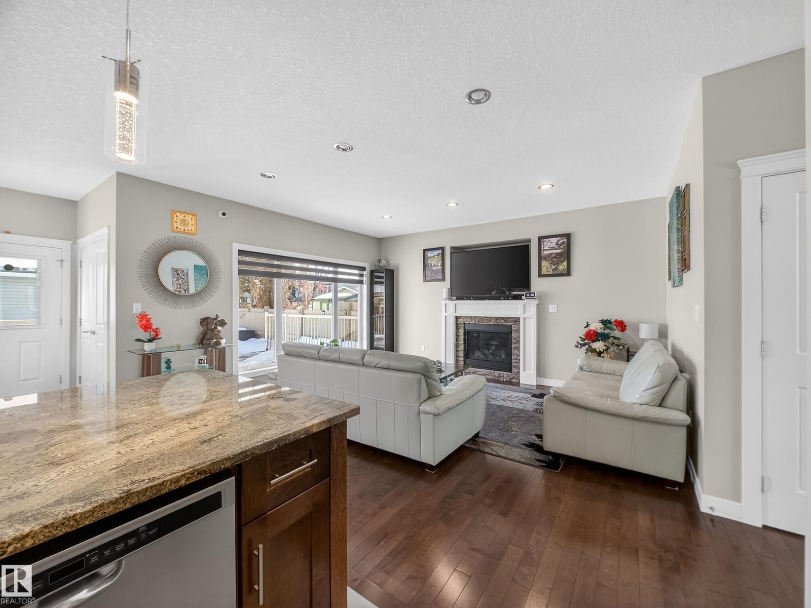 Great room and gas fireplace seen from the kitchen island