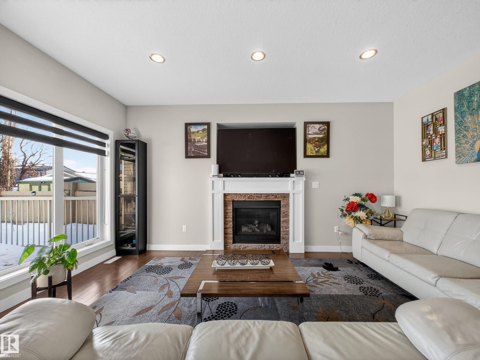 Great room with gas fireplace and large rear windows