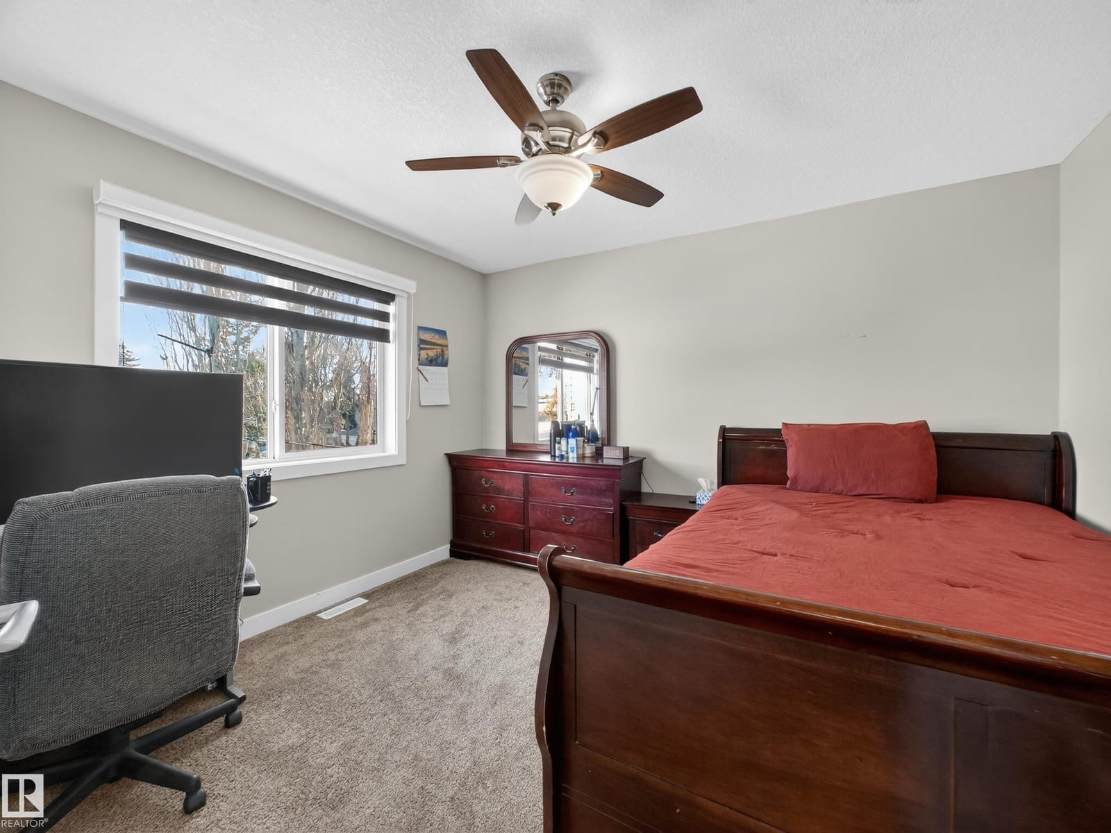 Upper-level bedroom with sleigh bed and workspace