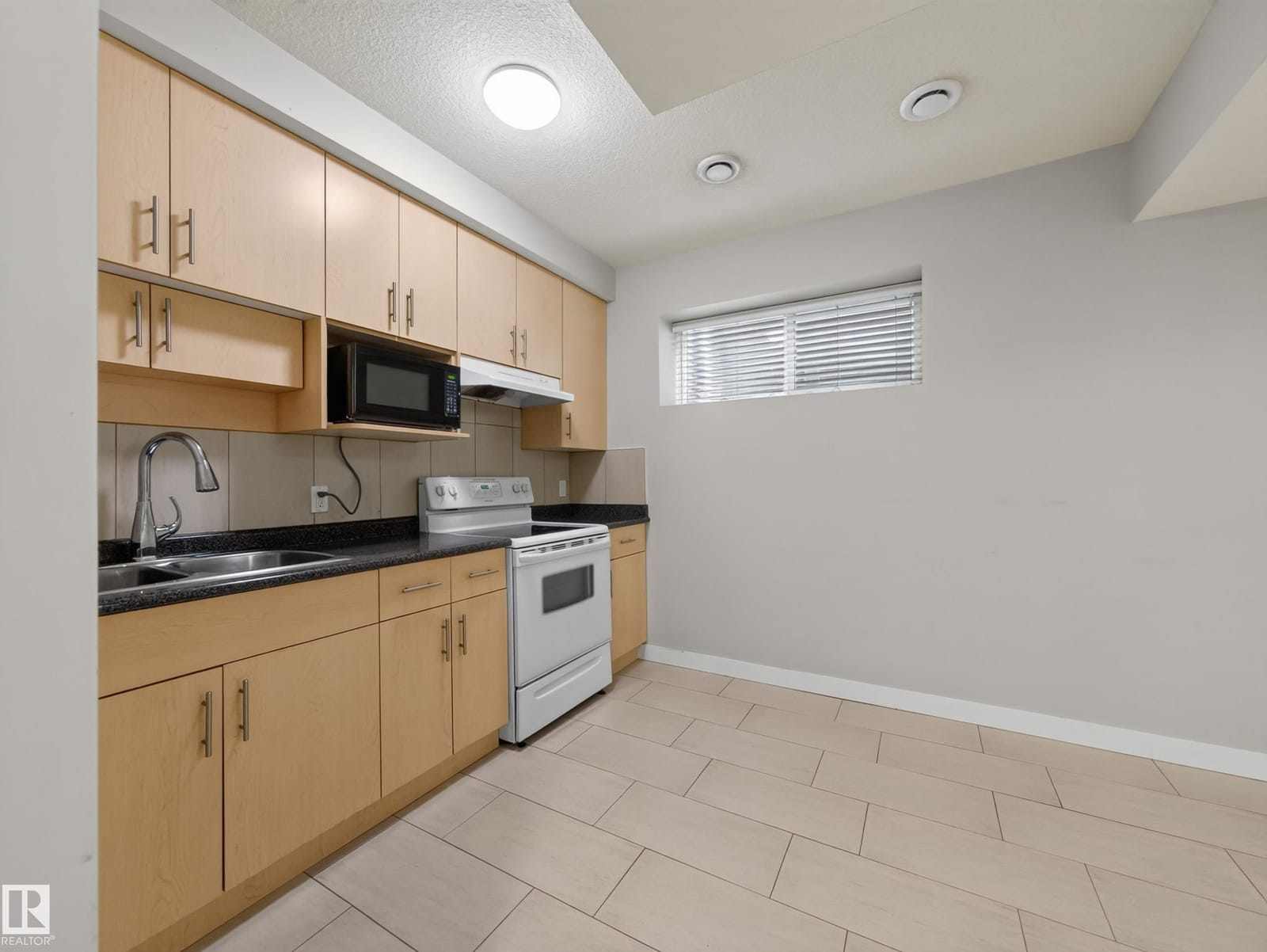 Suite kitchen with full-size range and microwave