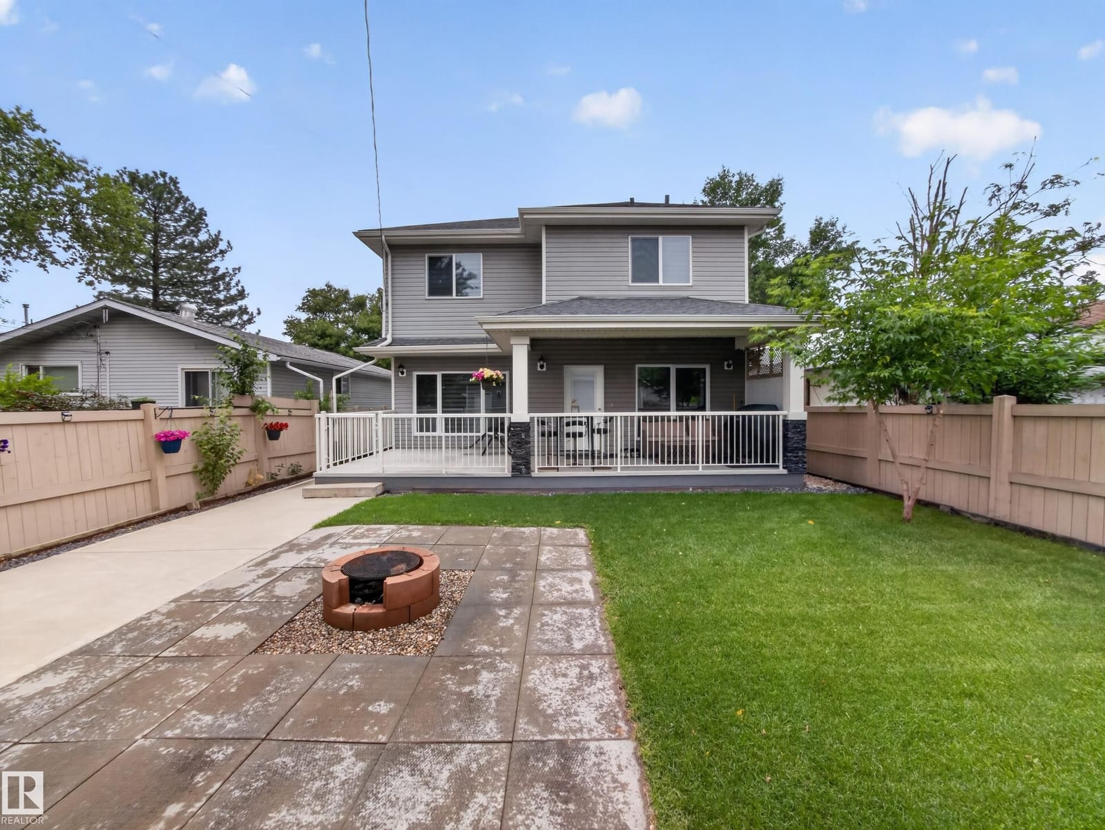 Back patio, fire pit and lawn behind the house
